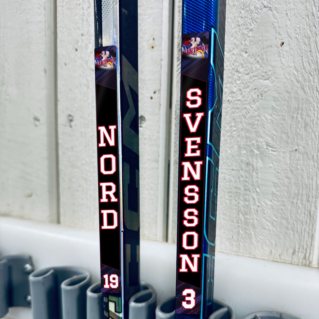 Haninge Anchors stick stickers applied to two hockey sticks in a rack